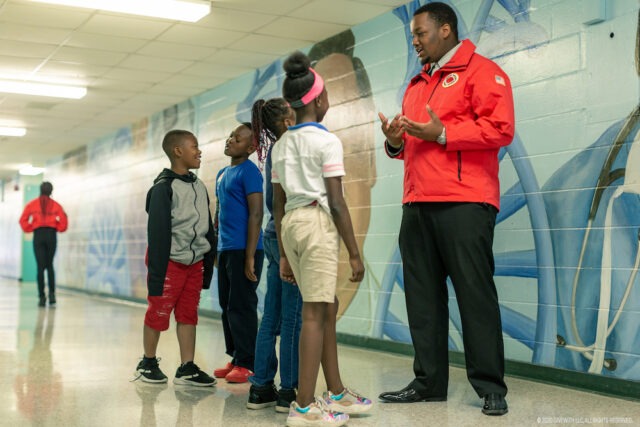 AmeriCorps member in Jacksonville, Florida speaks with a group of students.