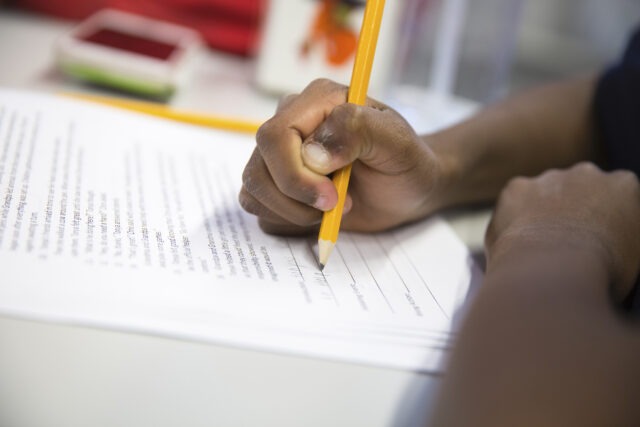 City Year student learning pencil and paper