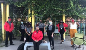 The Entergy team serving at Arthur Ashe Charter school gathers for a City Year team picture in the outdoor garden classroom