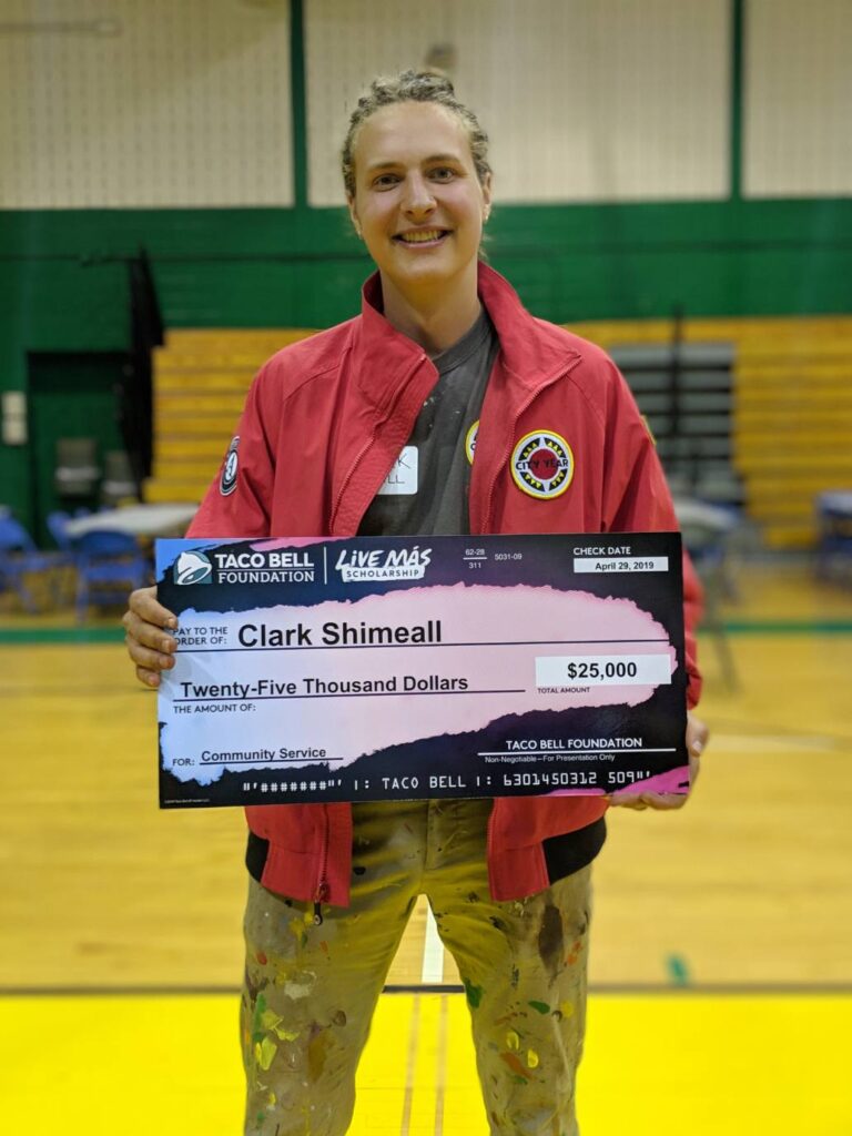 Clark holds his scholarship check from the Taco Bell Foundation.