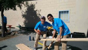 Carlos and fellow Alum Jackson Young volunteer at a Care Force event in East Palo Alto