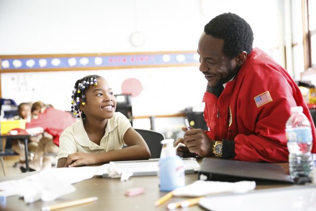 City Year AmeriCorps member with students in school