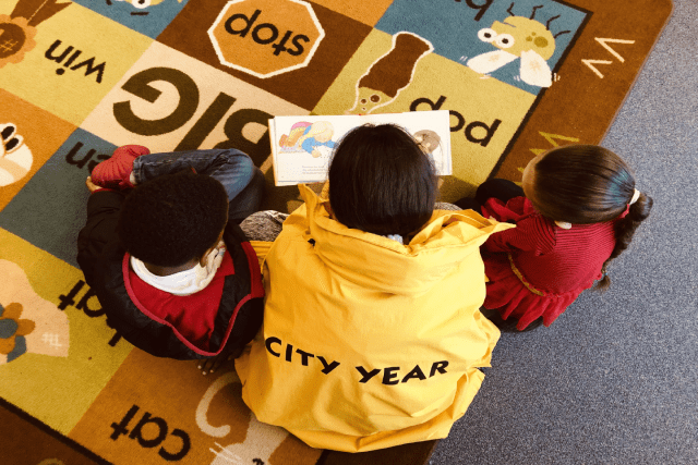 City Year in school service reading with students