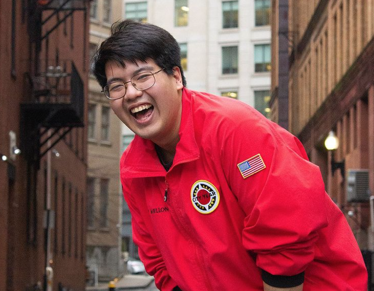 5 AmeriCorps members in red City Year jackets walk toward Lafayette school building