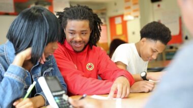 City Year AmeriCorps member student success coach with students