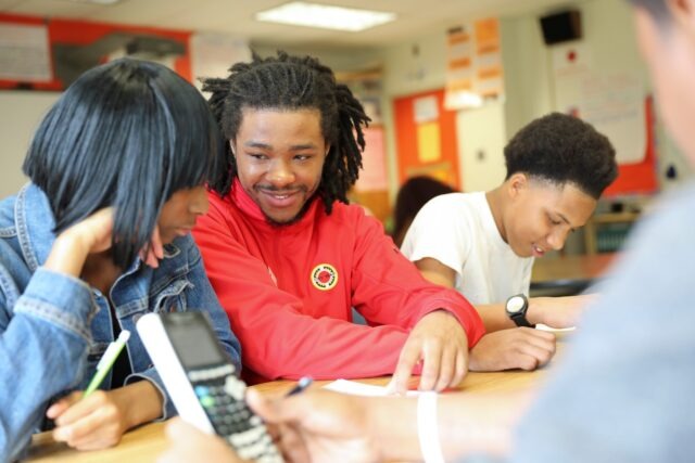 City Year AmeriCorps member student success coach with students