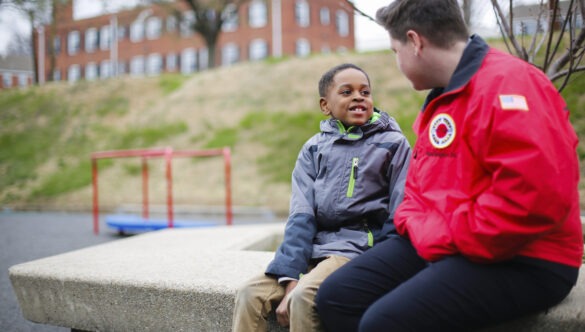 City Year AmeriCorps student success coach with student