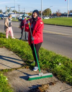 AmeriCorps Member Marissa Caldera volunteering with a street cleanup