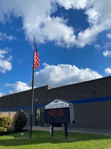 The Sign and Flag outside of CHSAT