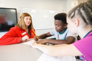 Service Leader Cloe Aitken Tutoring Two Students