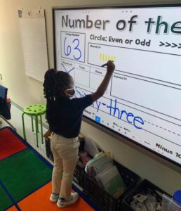 PPA Student working on a smart board