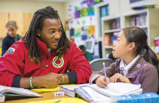 City Year AmeriCorps student success coach with students