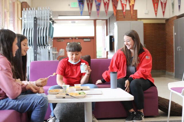 City Year AmeriCorps student success coach with students