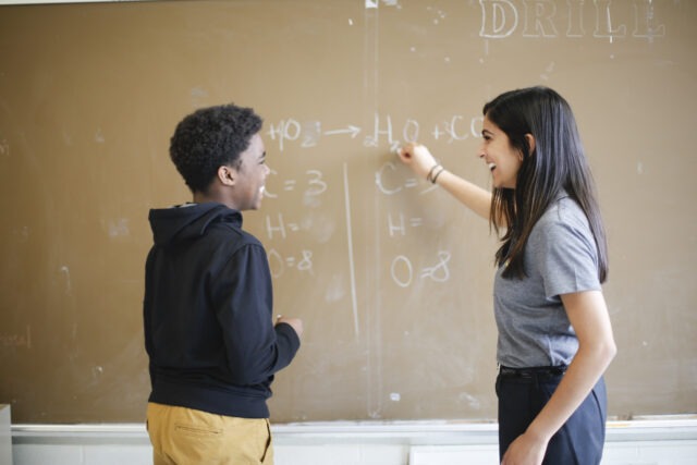 City Year AmeriCorps student success coach with student