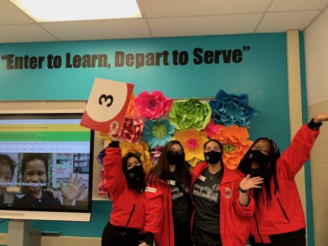 City Year AmeriCorps members red jacket in school