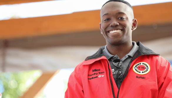 City Year Buffalo AmeriCorps member Miles smiles at the camera