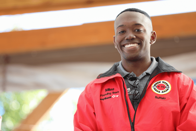 City Year Buffalo AmeriCorps member Miles smiles at the camera