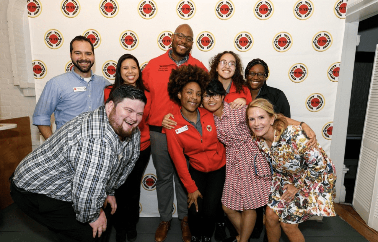 a group of City Year Buffalo staff members smiling at the camera