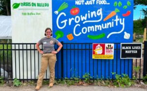 Alissa Cook in front of a mural at the Oasis on Ballou